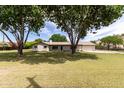 Charming single-story home surrounded by mature trees and lush greenery at 12548 E Cloud Rd, Chandler, AZ 85249