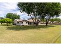 Well-maintained home with large, lush lawn and mature trees offer a serene setting at 12548 E Cloud Rd, Chandler, AZ 85249