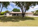 Inviting single-story home with lush front lawn and mature shade tree at 12548 E Cloud Rd, Chandler, AZ 85249