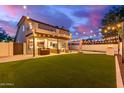 Well-manicured yard with covered patio and string lights, perfect for outdoor enjoyment at 1349 N Lakeshore Dr, Chandler, AZ 85226