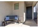 Covered entryway features a bench with decorative pillows and charming decor at 14601 W Valentine St, Surprise, AZ 85379