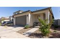 Charming beige home with a two-car garage and low-maintenance desert landscaping at 14601 W Valentine St, Surprise, AZ 85379
