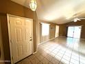 Bright living room features tiled floors, neutral walls, and sliding glass doors to the backyard at 1836 N Stapley Dr # 88, Mesa, AZ 85203