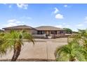 Attractive single-story home featuring a well-manicured front yard and a welcoming entrance at 18822 E Flintlock Dr, Queen Creek, AZ 85142