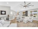 Bright living room with stylish furniture, seamlessly connects to dining area and outdoor patio at 18822 E Flintlock Dr, Queen Creek, AZ 85142