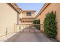 View of a house featuring a private gate and a multi-car garage, surrounded by lush greenery at 1950 W Park Pl, Chandler, AZ 85224