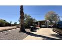 Charming home featuring low maintenance landscaping, driveway, and a mature palm tree at 201 S Greenfield Rd # 23, Mesa, AZ 85206