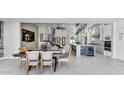 Open-concept dining area featuring modern lighting, table, and kitchen island at 20274 N 76Th Way, Scottsdale, AZ 85255