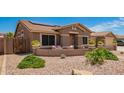 Single-story home featuring desert landscaping, solar panels, and a welcoming front porch at 20427 N 88Th Dr, Peoria, AZ 85382