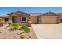 Charming single-story home with desert landscaping and a three car garage at 20427 N 88Th Dr, Peoria, AZ 85382