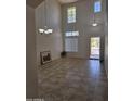 Bright living room with high ceilings, tile flooring, neutral walls, and lots of natural light at 20941 N Leona Blvd, Maricopa, AZ 85138