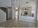 Open concept living space featuring neutral walls, tile floors, a dining area, and staircase at 20941 N Leona Blvd, Maricopa, AZ 85138