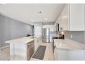 Bright kitchen with white cabinets, stainless steel appliances, and a large island at 23937 W Hopi St, Buckeye, AZ 85326