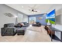 Cozy living room with tile floors, a ceiling fan, and sliding glass doors at 23937 W Hopi St, Buckeye, AZ 85326