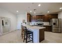 Well-lit eat-in kitchen featuring tile floors, stainless appliances, and stylish decor at 2511 W Queen Creek Rd # 337, Chandler, AZ 85248