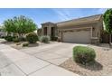 Lovely home with desert landscaping, a two-car garage, and a well-maintained lawn at 26271 N 46Th St, Phoenix, AZ 85050