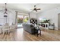 Bright living room featuring wood floors, a cozy fireplace, and access to the outdoor pool area at 26271 N 46Th St, Phoenix, AZ 85050