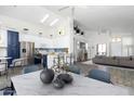 Bright living room featuring vaulted ceilings and seamless flow to the modern kitchen and dining area at 2641 E Brooks St, Gilbert, AZ 85296