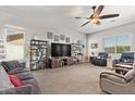 Inviting living room with neutral colors, plush carpeting, and a stylish ceiling fan at 2839 S Copperwood --, Mesa, AZ 85212