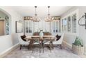 Elegant dining room featuring a rustic table, chandelier, and ample natural light at 28408 N 52Nd Way, Cave Creek, AZ 85331