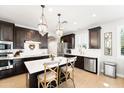 Gourmet kitchen with stainless appliances, a spacious island, and pendant lighting at 28408 N 52Nd Way, Cave Creek, AZ 85331
