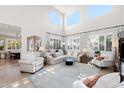 Bright living room boasts soaring ceilings, plantation shutters, and plenty of comfortable seating at 28408 N 52Nd Way, Cave Creek, AZ 85331