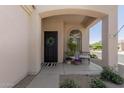 Charming front porch with elegant decor, including a wreath, bench, and potted plants at 3105 E Amber Ridge Way, Phoenix, AZ 85048