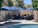 Inviting pool area with patio furniture and shade umbrellas, perfect for outdoor relaxation at 3105 E Amber Ridge Way, Phoenix, AZ 85048