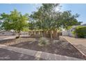 Quaint home boasts mature trees, desert landscaping, and a covered patio, enhancing its curb appeal at 3202 N 21St St, Phoenix, AZ 85016