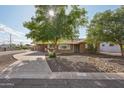 Inviting single-story home with a spacious driveway and xeriscaped front yard for low-maintenance appeal at 3202 N 21St St, Phoenix, AZ 85016