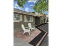 Charming front porch with two chairs and meticulous landscaping enhance this home's curb appeal at 3202 N 21St St, Phoenix, AZ 85016