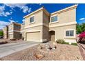 Tan, two-story home with desert landscaping, two car garage and tile roof at 337 N 103Rd Pl, Apache Junction, AZ 85120