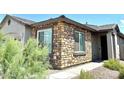 Close up view of the home's exterior elevation featuring stone detail and trim at 343 S 202Nd Dr, Buckeye, AZ 85326