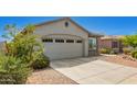 Charming single-story home features a two-car garage, neutral stucco, stone accents and low-maintenance desert landscaping at 343 S 202Nd Dr, Buckeye, AZ 85326