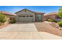 Charming single-story home features a two-car garage, neutral stucco, stone accents and low-maintenance desert landscaping at 343 S 202Nd Dr, Buckeye, AZ 85326