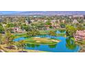 Scenic aerial view of a golf course community with tranquil lakes, lush fairways, and beautiful homes at 3800 S Cantabria Cir # 1077, Chandler, AZ 85248