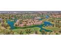 Stunning aerial view of lakeside homes on a lush golf course community, offering serene waterfront living at 3800 S Cantabria Cir # 1077, Chandler, AZ 85248