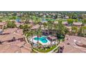 Aerial view of a sparkling community pool and hot tub amidst lush landscaping and luxurious homes at 3800 S Cantabria Cir # 1077, Chandler, AZ 85248