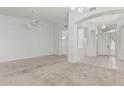 Spacious, light-filled living room with neutral-toned walls and carpet flooring at 408 N Falcon Ct, Gilbert, AZ 85234