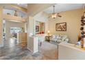 Cozy living room with neutral tones, a ceiling fan, and an open layout, perfect for relaxation and entertaining guests at 44574 W High Desert Trl, Maricopa, AZ 85139