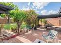Inviting brick patio featuring a pergola, lush greenery, and comfortable seating, perfect for outdoor entertaining at 4502 N 17Th Ave, Phoenix, AZ 85015