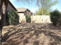 Spacious backyard featuring gravel ground cover and mature landscaping providing shade and privacy at 4601 W Fortune Dr, Anthem, AZ 85086
