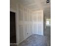 Unfinished hallway featuring drywall and open doorways at 46887 W Old Timer Rd, Maricopa, AZ 85139
