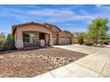 Charming single-story home with a well-maintained lawn and a spacious three car driveway at 4723 W Samantha Way, Laveen, AZ 85339