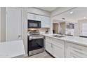 Contemporary kitchen featuring white cabinets, stainless steel appliances, quartz counters, and modern finishes at 4901 S Calle Los Cerros Dr # 119, Tempe, AZ 85282