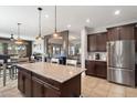 Open-concept kitchen with a central island, granite countertops, and modern appliances at 5543 W Kowalsky Ln, Laveen, AZ 85339