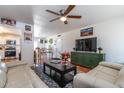 The open-concept living room boasts neutral couches, a stylish rug, and a view of the kitchen and breakfast area at 6501 W Columbus Ave, Phoenix, AZ 85033