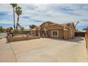 Spacious property with a long driveway and manicured landscaping, offering curb appeal at 6701 W Catalina Dr, Phoenix, AZ 85033