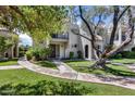 Beautiful home with lovely greenery, a pathway to the front door and shade tree at 8225 N Central Ave # 44, Phoenix, AZ 85020