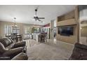 Open-concept living space with tiled floors, neutral tones, and a seamless transition to the kitchen at 843 E Vera Ln, Tempe, AZ 85284